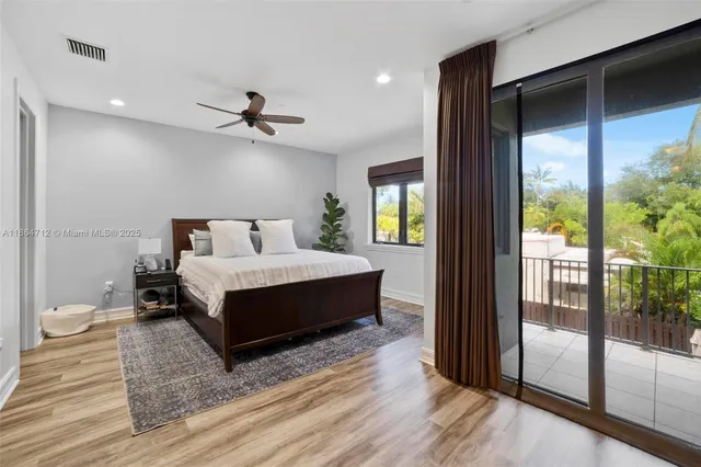 a bedroom with a bed and a glass door