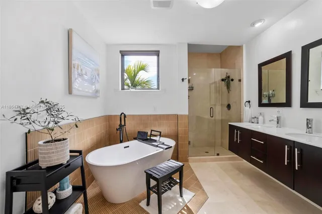 a en suite bathroom with a granite countertop sink a toilet and mirror