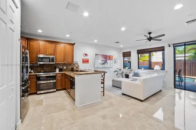 a kitchen with counter top space with stainless steel appliances