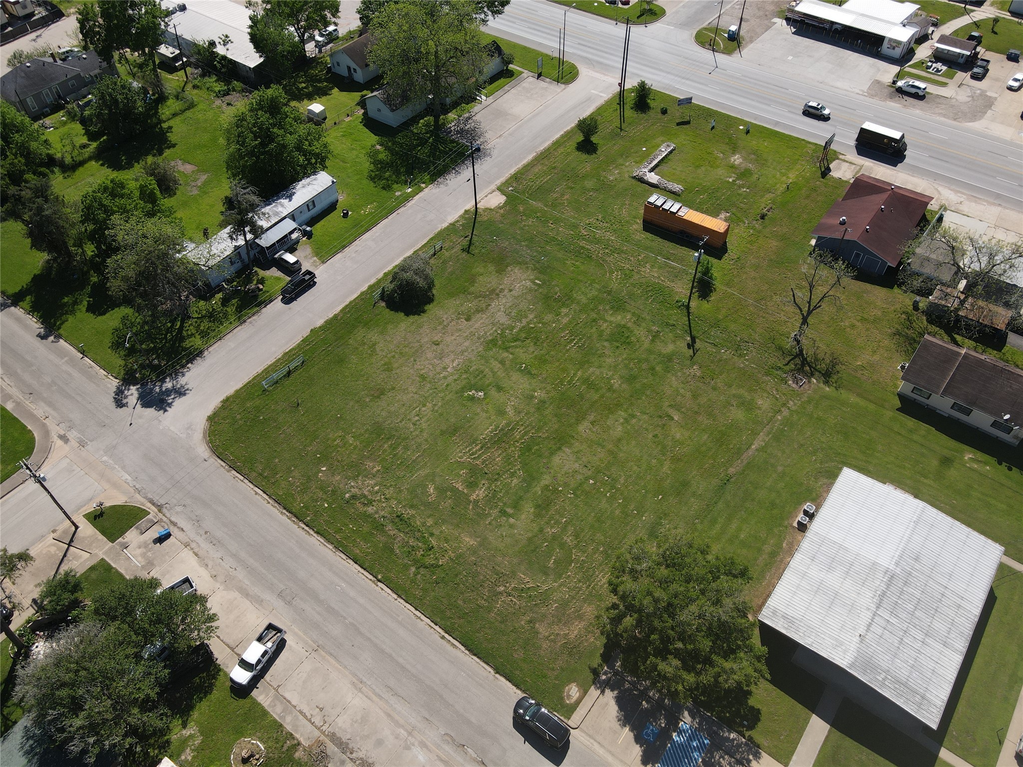 936 New Orleans Street Hempstead, TX 77445 - Photo 11 of 11 an aerial view of a house with a garden and lake view