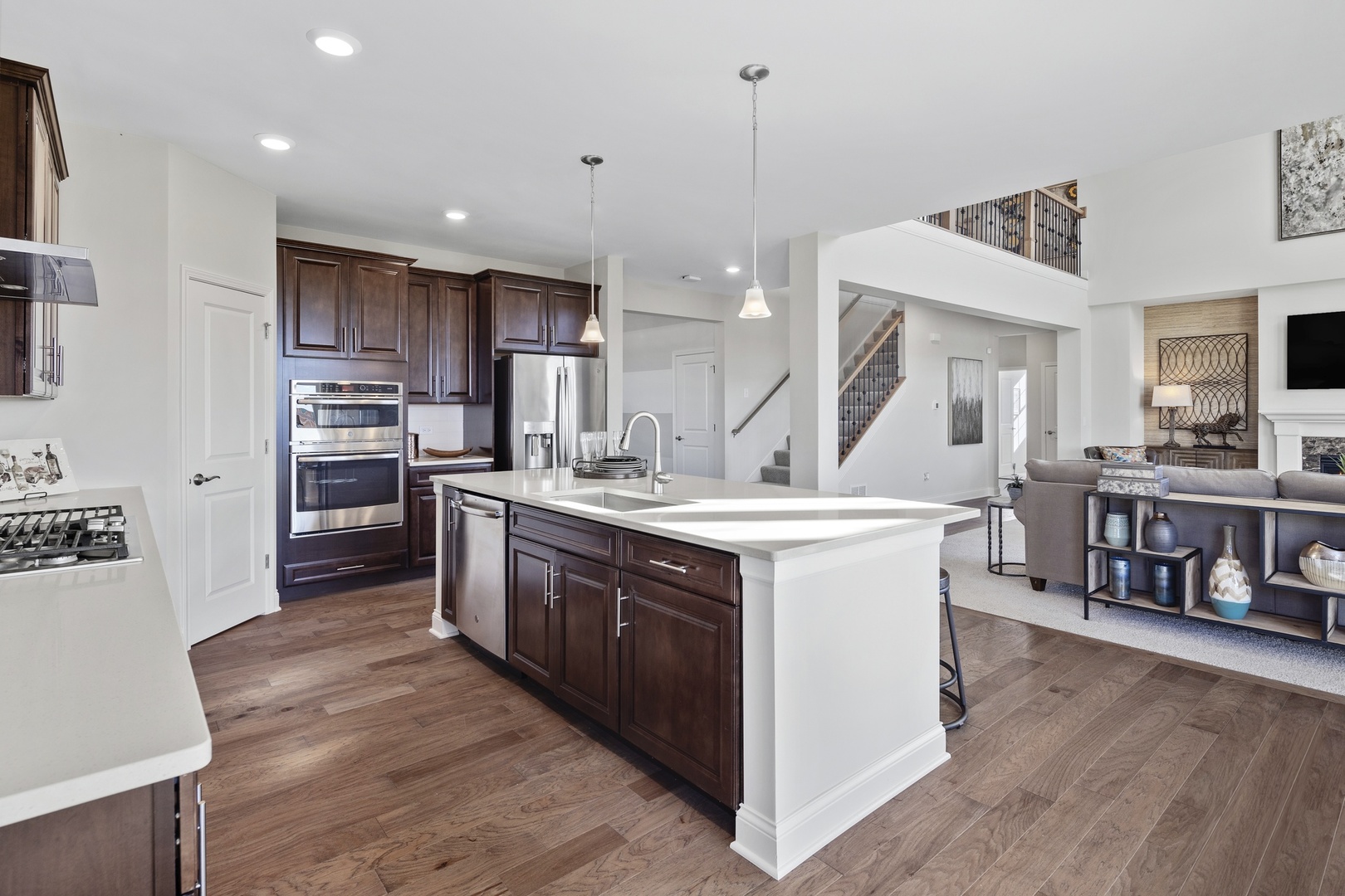 3602 Emerald Road Elgin, IL 60124 - Photo 6 of 36 a kitchen with stainless steel appliances granite countertop a sink a stove and a wooden floors
