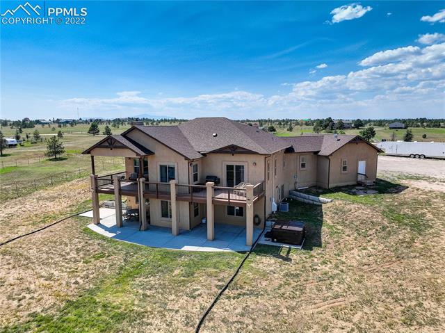18185 Ranch Hand Road Peyton, CO 80831 - Photo 11 of 14 Basement patio wraps around to hot tub