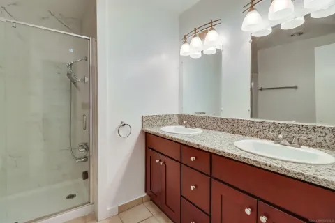 a bathroom with a glass shower door