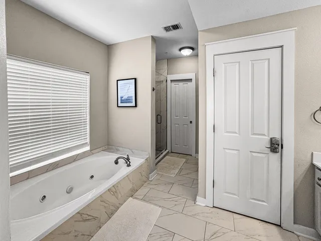 a bathroom with a bathtub and a shower