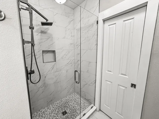 a bathroom with a glass shower door
