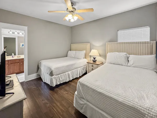 a bedroom with two beds and a chandelier
