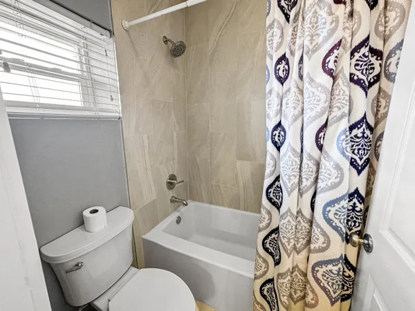 a bathroom with a toilet and shower