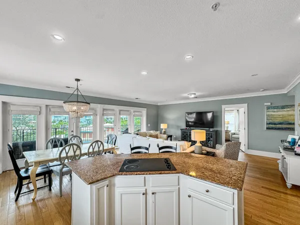 a kitchen with granite countertop a sink and living room view