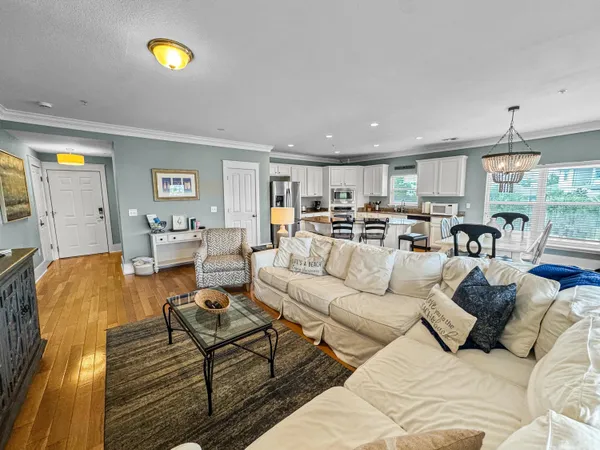 a living room with furniture and kitchen view