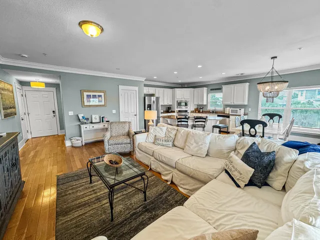 a living room with furniture and kitchen view
