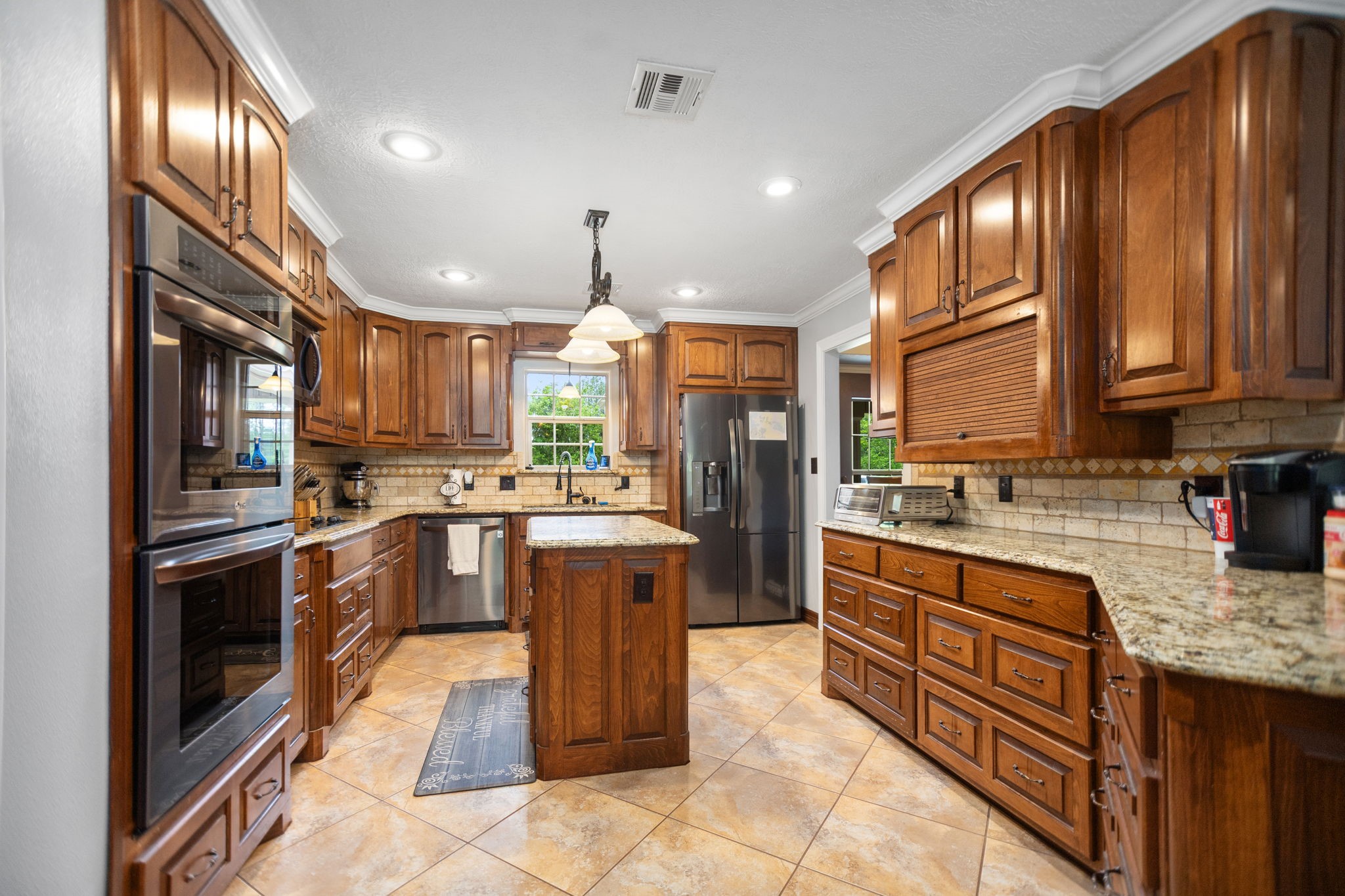 4145 Fm 770 Road Kountze, TX 77625 - Photo 19 of 38 a kitchen with stainless steel appliances granite countertop a refrigerator a stove a sink and a microwave