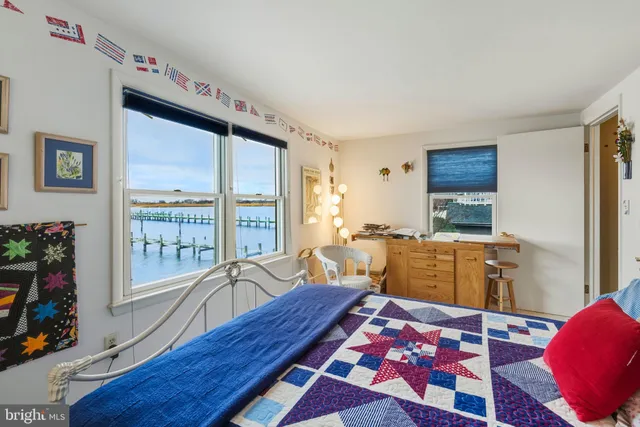 a bedroom with furniture and a large window