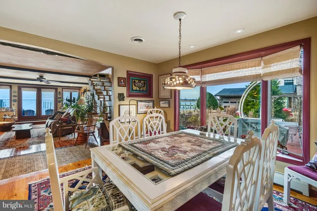 a living room with furniture flat screen tv and a large window