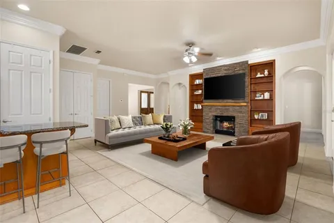 a living room with furniture a fireplace and a flat screen tv