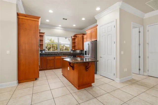 a kitchen with stainless steel appliances granite countertop a refrigerator and a sink