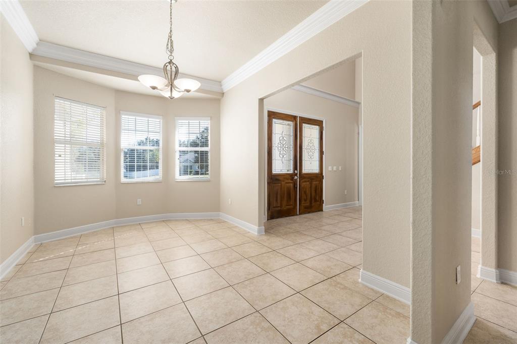 3950 Southeast 39th Circle Ocala, FL 34480 - Photo 17 of 40 a view of an empty room with windows and chandelier