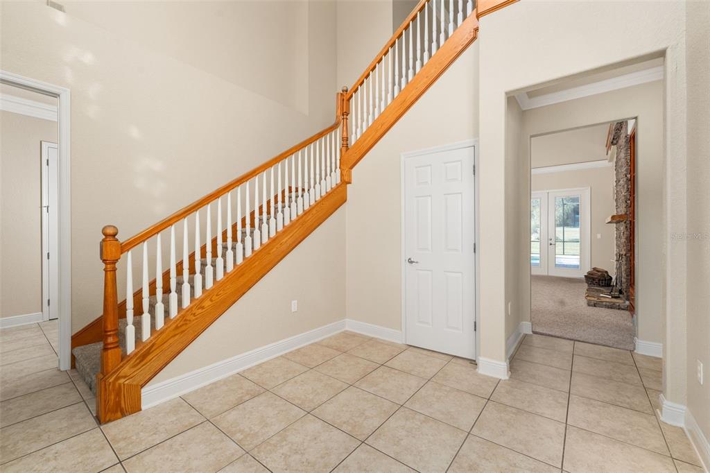 3950 Southeast 39th Circle Ocala, FL 34480 - Photo 18 of 40 a view of a hallway with entryway and stairs