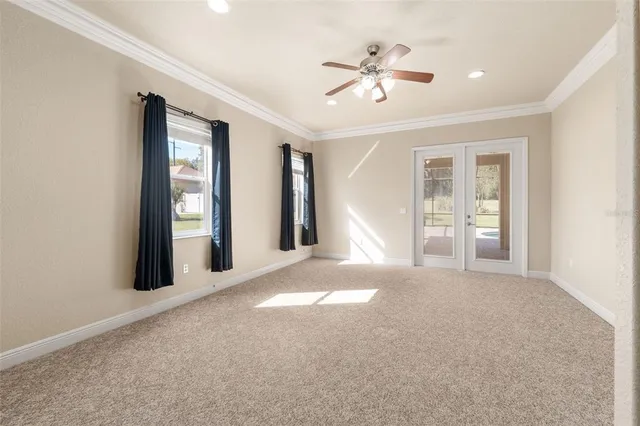 a view of a livingroom with a ceiling fan and window