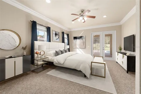 a bedroom with a bed a mirror on dresser and a flat screen tv