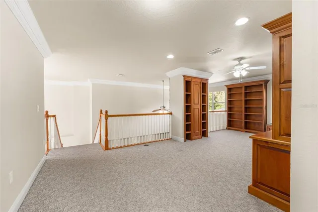 a view of an empty room with closet and en suite bathroom