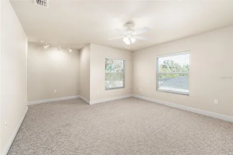 a view of an empty room with a ceiling fan