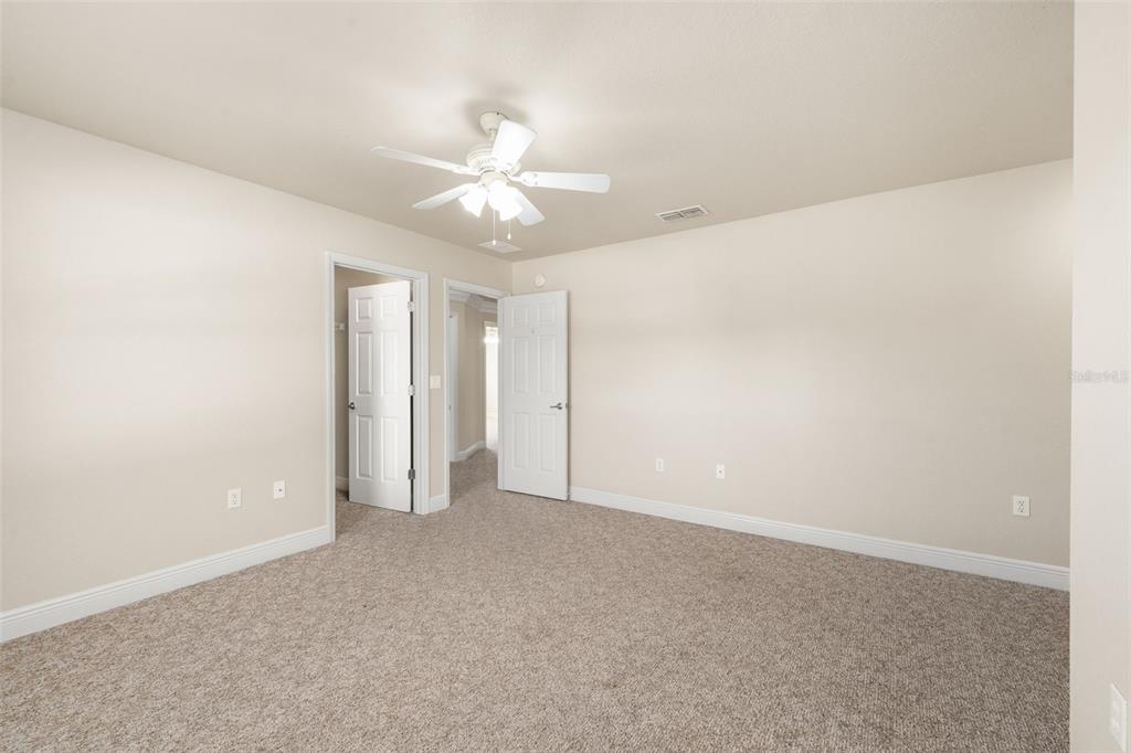 3950 Southeast 39th Circle Ocala, FL 34480 - Photo 31 of 40 an empty room with a ceiling fan and a window