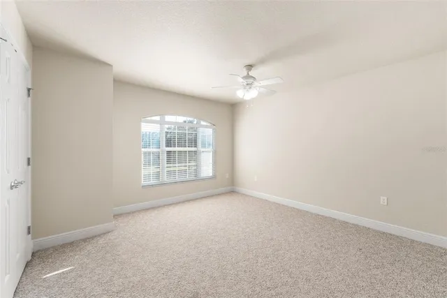 a spacious bathroom with a granite countertop sink a mirror and a shower