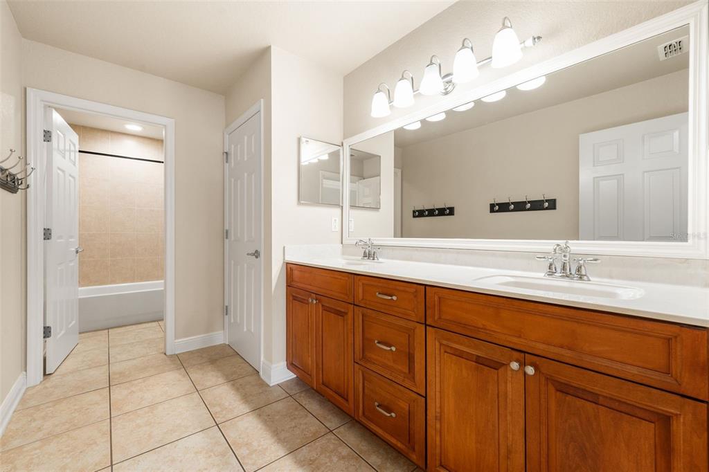3950 Southeast 39th Circle Ocala, FL 34480 - Photo 33 of 40 a spacious bathroom with a granite countertop sink a mirror and a shower