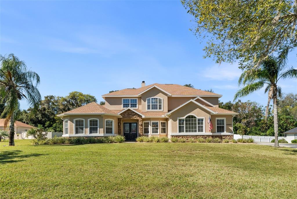 3950 Southeast 39th Circle Ocala, FL 34480 - Photo 6 of 40 a front view of a house with a garden