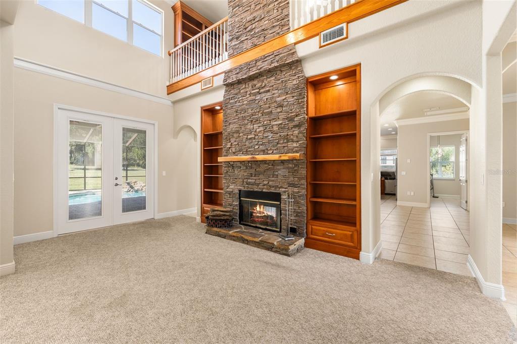 3950 Southeast 39th Circle Ocala, FL 34480 - Photo 10 of 40 an empty room with a fireplace cabinets and windows