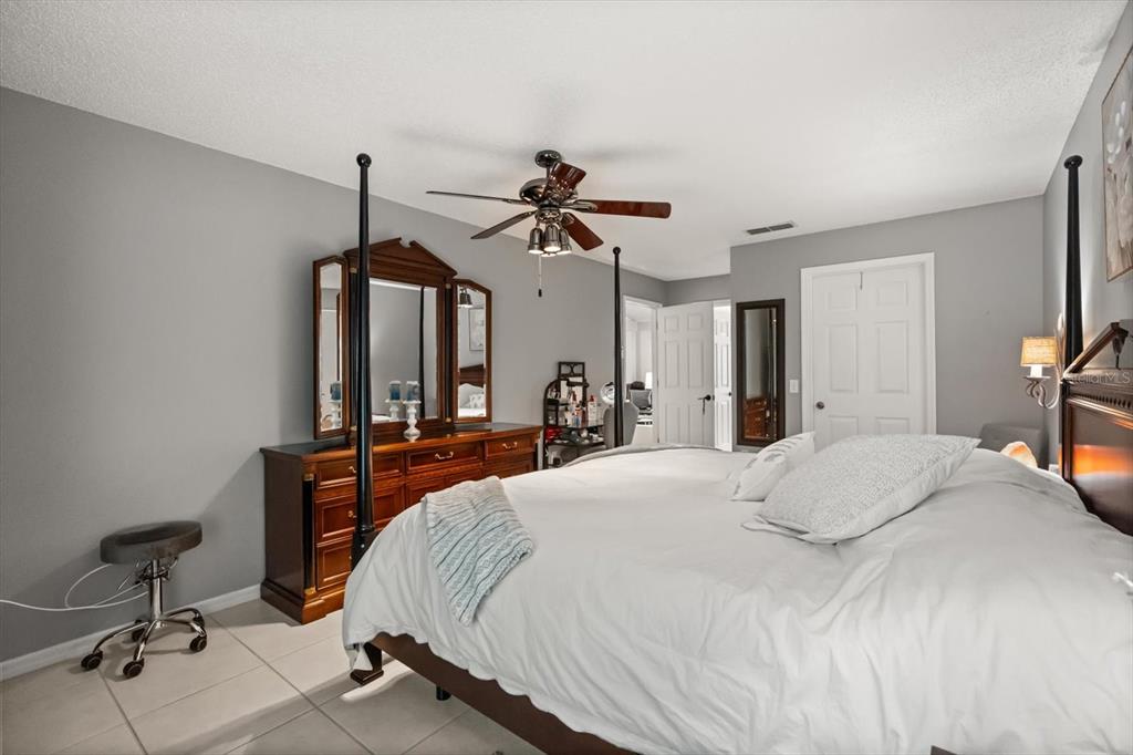 1336 Star Court Deltona, FL 32725 - Photo 17 of 34 a bedroom with a bed and a chandelier