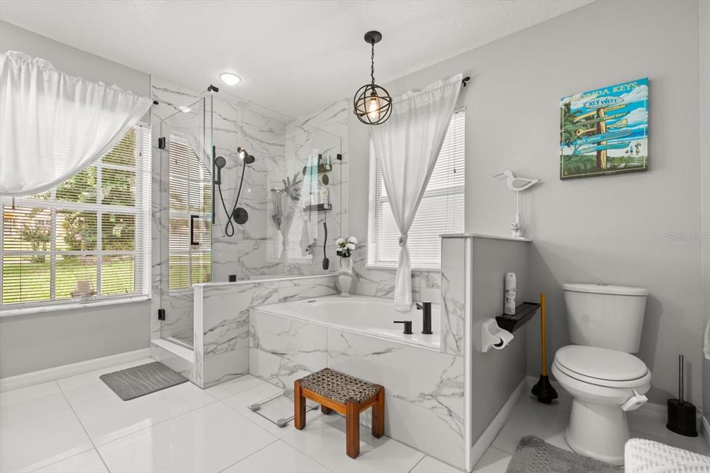 1336 Star Court Deltona, FL 32725 - Photo 18 of 34 a spacious bathroom with a sink a toilet a window and a shower