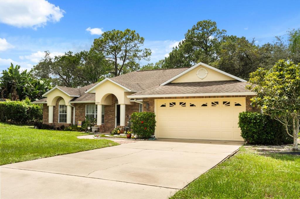1336 Star Court Deltona, FL 32725 - Photo 2 of 34 a front view of a house with a yard and garage