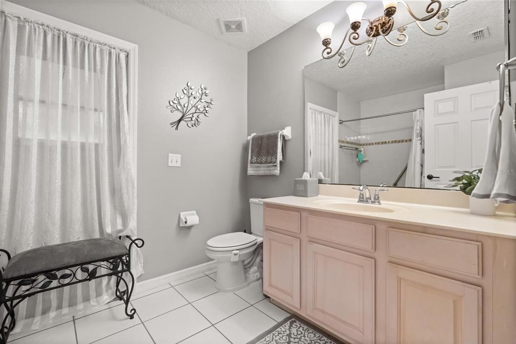 1336 Star Court Deltona, FL 32725 - Photo 22 of 34 a bathroom with a toilet sink and mirror