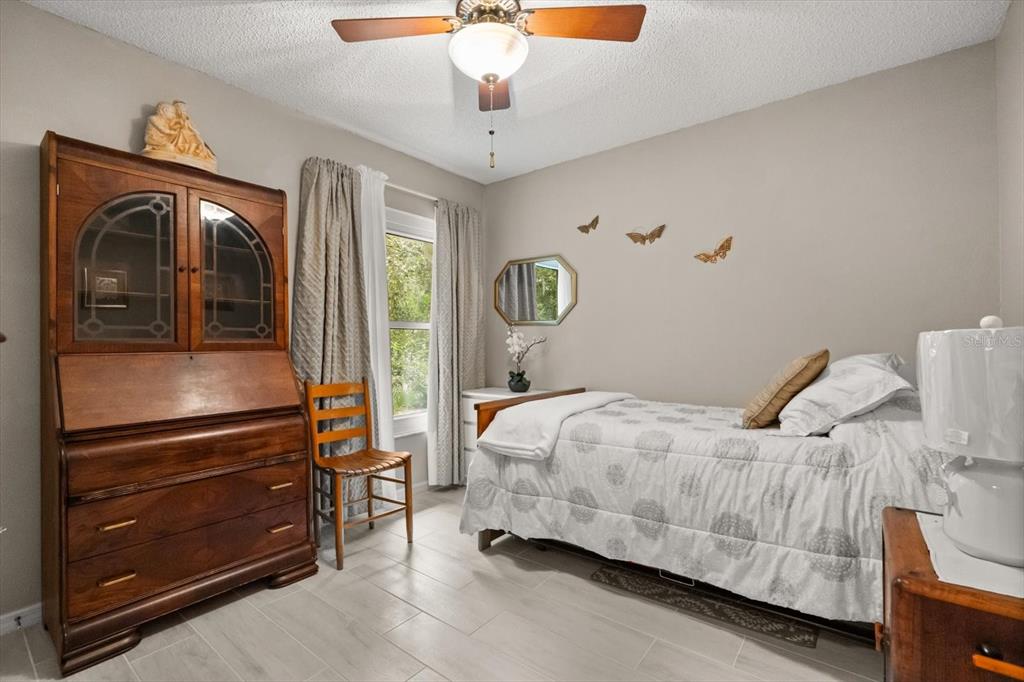 1336 Star Court Deltona, FL 32725 - Photo 28 of 34 a bedroom with a bed and wooden floor