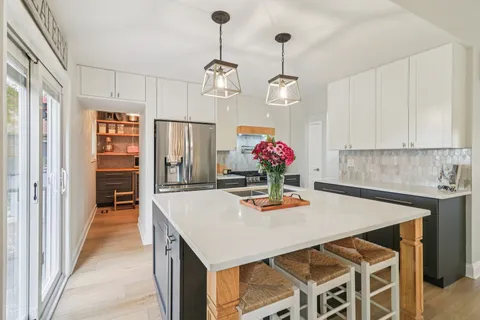 a kitchen with a table and chairs in it