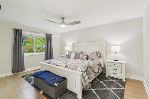 a bedroom with a bed and a window