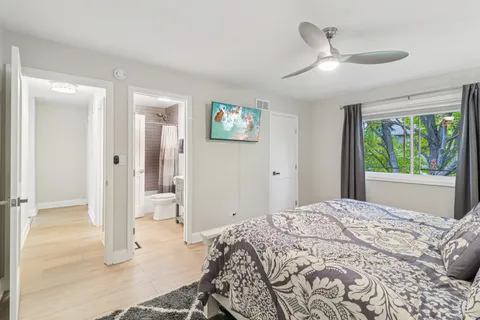 a bedroom with a bed and a window