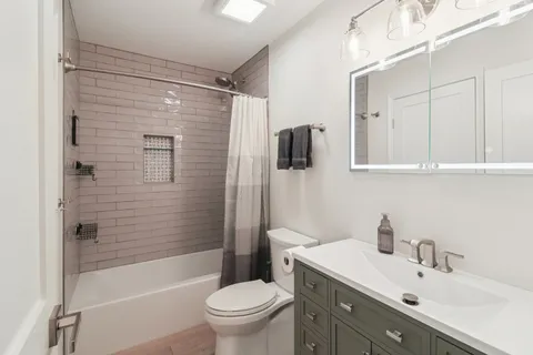 a bathroom with a sink toilet and shower