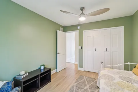 a bedroom with a bed and a ceiling fan