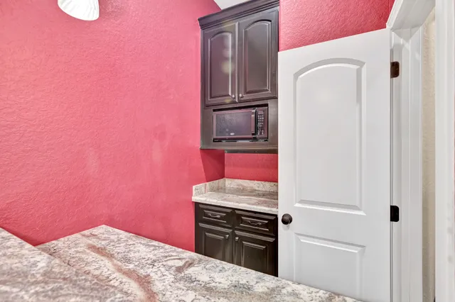 a kitchen with a refrigerator stove and microwave