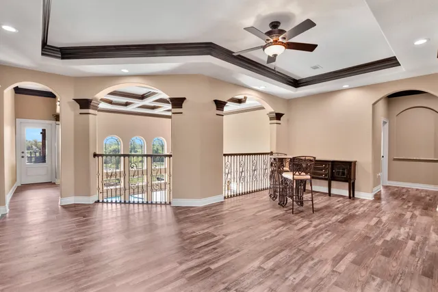 a view of a livingroom with furniture and a ceiling fan