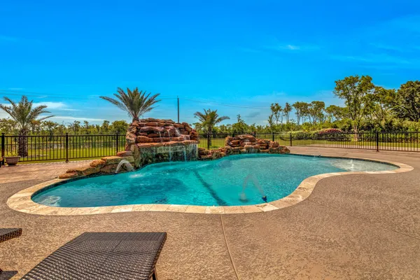 a view of a swimming pool and a yard