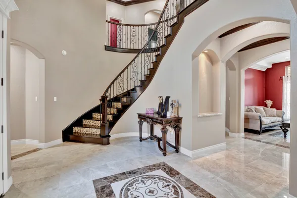 a living room with furniture and stairs