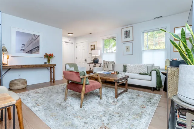 a living room with furniture a window and a table