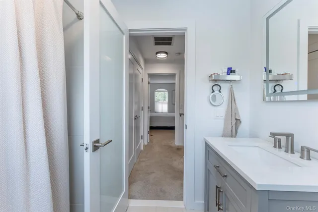 a bathroom with a sink vanity and mirror