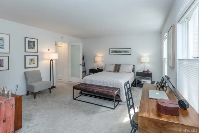 a bedroom with a bed couch and a window