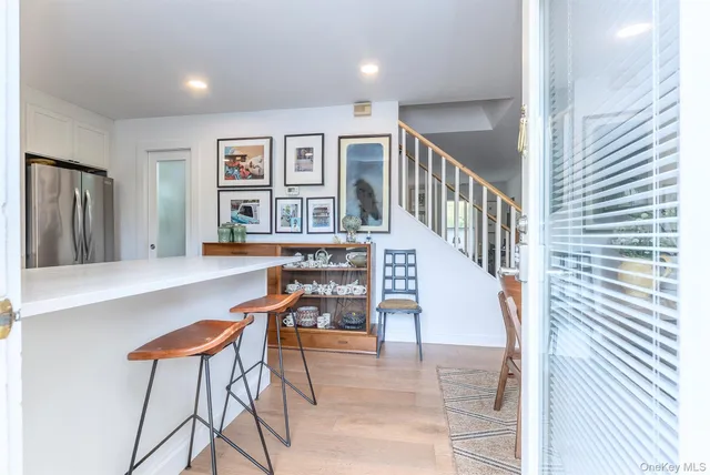 a dining room with furniture and a window