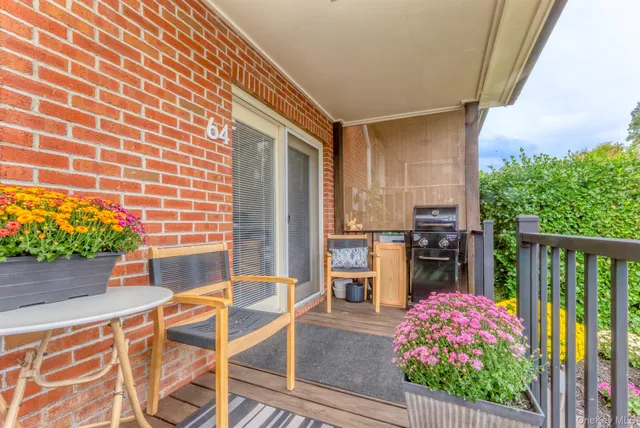 a front view of a house with outdoor seating
