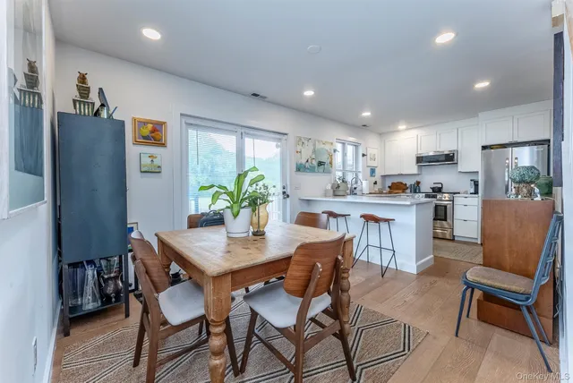 a view of a dining room with furniture and a potted plant